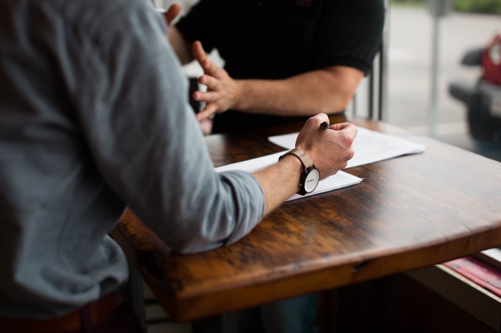 Two men engaged in sales conversation